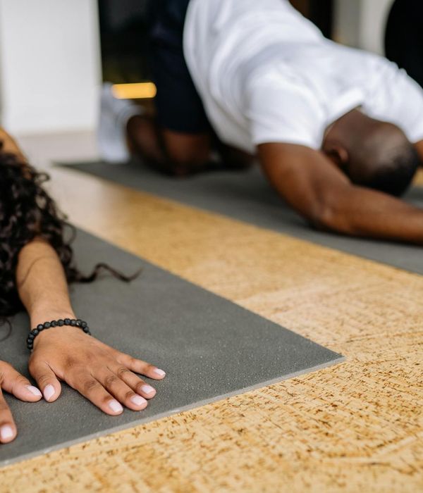 Person in a calm yoga pose in a serene studio setting.